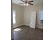 Bedroom featuring two windows, a ceiling fan, wood floors and neutral paint at 1924 30Th S St, St Petersburg, FL 33712