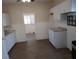 Bright kitchen featuring white cabinetry, laminate floors, and granite countertops at 1924 30Th S St, St Petersburg, FL 33712