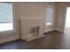 Living room featuring decorative fireplace, laminate flooring and natural light at 1924 30Th S St, St Petersburg, FL 33712