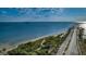 Expansive aerial shot showcasing Dunedin Causeway, a scenic road stretching over tranquil waters under a cloudy sky at 1926 Fairway W Cir, Dunedin, FL 34698