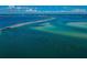 Stunning aerial view of a sandy causeway with crystal-clear waters on a sunny day at 1926 Fairway W Cir, Dunedin, FL 34698