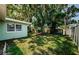 The backyard is surrounded by lush greenery and trees, offering a private retreat at 1926 Fairway W Cir, Dunedin, FL 34698