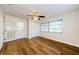 Bedroom featuring one window, a ceiling fan, wood flooring, and closet at 1926 Fairway W Cir, Dunedin, FL 34698