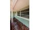 Welcoming front porch with decorative columns, tiled flooring, and charming details at 1926 Fairway W Cir, Dunedin, FL 34698