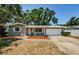 Charming home featuring a well-maintained front yard and a convenient attached garage at 1926 Fairway W Cir, Dunedin, FL 34698