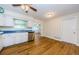 Bright kitchen featuring white cabinets, stainless steel appliances, and wood flooring at 1926 Fairway W Cir, Dunedin, FL 34698