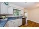 Bright kitchen featuring white cabinets, stainless steel appliances, and wood flooring at 1926 Fairway W Cir, Dunedin, FL 34698