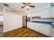 Kitchen featuring white cabinets, stainless steel appliances, and wood flooring at 1926 Fairway W Cir, Dunedin, FL 34698