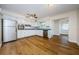 Bright kitchen featuring white cabinets, stainless steel appliances, and wood flooring at 1926 Fairway W Cir, Dunedin, FL 34698