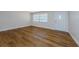 Bright living room featuring laminate floors, a front door, and ample natural light at 1926 Fairway W Cir, Dunedin, FL 34698