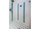 The shower is clean with white and blue tile, along with a silver shower head at 1926 Fairway W Cir, Dunedin, FL 34698