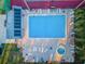 An aerial shot reveals a pool deck with lots of lounge chairs at 204 Lake Charles Ct, Oldsmar, FL 34677