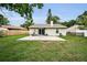 A large backyard with lush green grass and a patio offers plenty of outdoor space at 204 Lake Charles Ct, Oldsmar, FL 34677