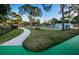 Basketball court and tennis courts bordered by a sidewalk, with lush green grass at 204 Lake Charles Ct, Oldsmar, FL 34677