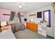 Bright bedroom with decoratively painted walls and ceiling fan at 204 Lake Charles Ct, Oldsmar, FL 34677