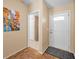 Inviting home foyer featuring classic parquet flooring, fresh white door, and neutral wall tones at 204 Lake Charles Ct, Oldsmar, FL 34677