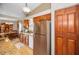 Galley style kitchen with wood cabinets and stainless-steel appliances, adjoining dining room at 204 Lake Charles Ct, Oldsmar, FL 34677