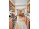Spacious kitchen with wooden cabinets, tile floors, stainless steel appliances, and adjoining dining area at 204 Lake Charles Ct, Oldsmar, FL 34677