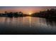 Stunning lake view at sunset, highlighting the water's calm surface and surrounding trees at 204 Lake Charles Ct, Oldsmar, FL 34677