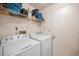 Laundry room with washer, dryer, and overhead storage at 204 Lake Charles Ct, Oldsmar, FL 34677