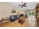 Comfortable living room features a brick fireplace, natural light, and classic parquet wood floors at 204 Lake Charles Ct, Oldsmar, FL 34677
