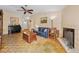 Spacious living room featuring parquet floors, fireplace, ample seating, and plenty of natural light at 204 Lake Charles Ct, Oldsmar, FL 34677