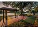 Picnic area with picnic tables and grill with lake view in the background at 204 Lake Charles Ct, Oldsmar, FL 34677