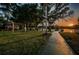 Scenic park featuring a playground, lakeside walkway, and mature trees, perfect for Gathering enjoyment at 204 Lake Charles Ct, Oldsmar, FL 34677