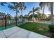 View of the fenced entrance into a sports complex with a basketball and tennis court, plus a pool at 204 Lake Charles Ct, Oldsmar, FL 34677