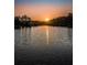 Picturesque sunset reflecting on the serene lake, creating a peaceful and inviting atmosphere at 204 Lake Charles Ct, Oldsmar, FL 34677