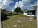 The backyard features a large lawn, privacy fence, and easy access to the home's screened in porch at 2195 Academy Dr, Clearwater, FL 33764