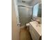 Cozy bathroom features a shower, vanity with sink, and neutral-toned decor at 2195 Academy Dr, Clearwater, FL 33764