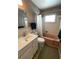 Bathroom featuring a tiled shower/tub, white vanity and a pink tub at 2195 Academy Dr, Clearwater, FL 33764