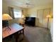 Bedroom featuring carpet, natural light, a ceiling fan and piano at 2195 Academy Dr, Clearwater, FL 33764