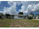 Lovely home with a lush green lawn, charming details, and inviting curb appeal at 2195 Academy Dr, Clearwater, FL 33764