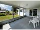 The screened porch features access to the backyard, a gray tile floor, and lots of room for outdoor living at 2195 Academy Dr, Clearwater, FL 33764