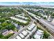An aerial view showcases the townhomes with rooftop terraces near the highway and cityscape at 2442 W Mississippi Ave # 5, Tampa, FL 33629