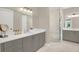 Bathroom with double vanity, tile floors and spacious glass shower at 2442 W Mississippi Ave # 5, Tampa, FL 33629