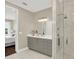 Modern bathroom featuring gray vanity, walk-in shower with glass door, and view into main bedroom at 2442 W Mississippi Ave # 5, Tampa, FL 33629