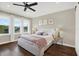 This bedroom boasts hardwood floors, neutral walls, three large windows, and a modern ceiling fan at 2442 W Mississippi Ave # 5, Tampa, FL 33629