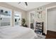Light and bright bedroom with two windows, gray walls, open door to bathroom, and black metal shelves at 2442 W Mississippi Ave # 5, Tampa, FL 33629