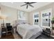 Comfortable bedroom with large windows, ceiling fan, and neutral decor at 2442 W Mississippi Ave # 5, Tampa, FL 33629