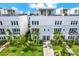 Beautiful modern townhomes feature lush landscaping, private balconies, and a charming brick pathway at 2442 W Mississippi Ave # 5, Tampa, FL 33629