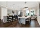 Open kitchen with stainless steel appliances, center island with seating, and hardwood floors at 2442 W Mississippi Ave # 5, Tampa, FL 33629