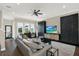 Comfortable living room with neutral tones, large TV, ceiling fan and bright windows at 2442 W Mississippi Ave # 5, Tampa, FL 33629