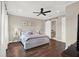 Main bedroom features hardwood floors, ceiling fan, ensuite bathroom and closet with barn door at 2442 W Mississippi Ave # 5, Tampa, FL 33629