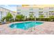 Community pool is surrounded by green bushes and offers multiple seating areas for relaxing and enjoying the weather at 2442 W Mississippi Ave # 5, Tampa, FL 33629
