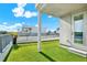A rooftop patio features artifical turf, a privacy fence, and an entry door to the unit at 2442 W Mississippi Ave # 5, Tampa, FL 33629