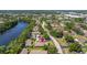 Aerial shot featuring a picturesque community adjacent to a lake and a quiet residential street at 2510 Laurelwood Dr # 5B, Clearwater, FL 33763