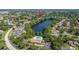 Overhead view of the neighborhood adjacent to a picturesque lake and a community pool with recreational amenities at 2510 Laurelwood Dr # 5B, Clearwater, FL 33763